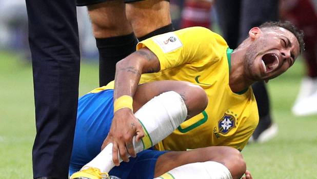 Neymar goes down injured during Brazil's World Cup playoff match against Mexico in Samara.