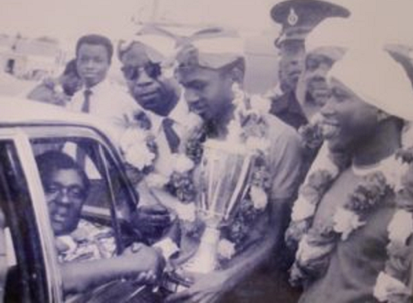 The late B.K. Edusei (in car) receiving a trophy from then Kotoko captain Ibrahim Sunday flanked by his teammate, Osei Kofi (right)