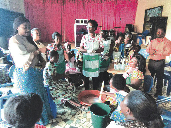 Mrs Justina Marigold Assan (left) addressing the participants during the training. Looking on is Madam Monica Esi Crentsil (standing middle), facilitator for the training