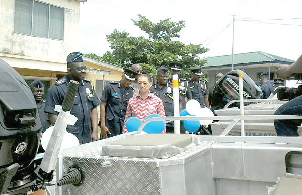 The IGP, Mr David Asante-Apeatu (left), the Japanese Ambassador to Ghana, Mr Tsutomu Himeno, and other senior officers of the Ghana Police Service inspecting the boats after the hand-over ceremony. INSET:  The two patrol boats. 