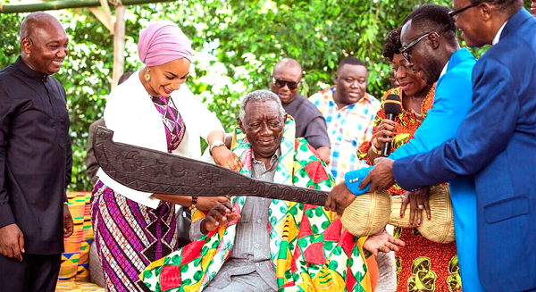 Former President Kufuor being decorated with a ‘Kente’ sach