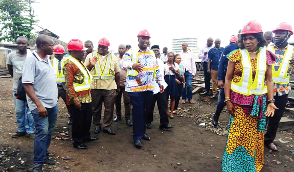 Mr Joe Ghartey (third left), Minister of Railways Development in a discussion with the acting Managing Director of the GRCL, Mr John Essel (left), during a tour of the Accra-Nsawam rail line. On the far right is Madam Elizabeth Sackey, Deputy Greater Accra Regional Minister