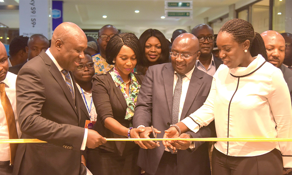 Dr Mahamudu Bawumia (2nd right) being assisted to cut the tape for the official opening of the Expo