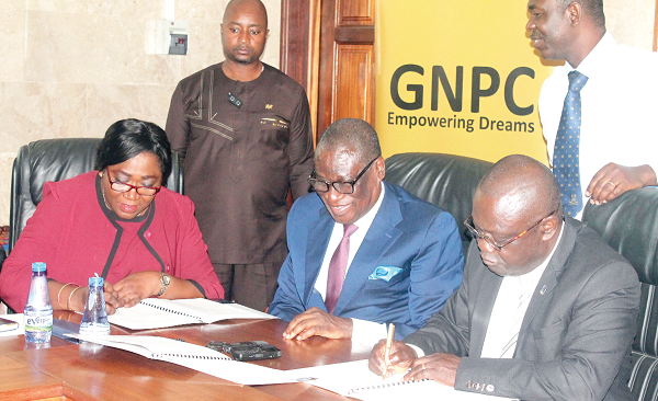 Ms Matilda Ohene (left), Secretary to the CEO of the Ghana National Petroleum Corporation (GNPC), and Prof. Ebenezer Oduro Owusu (3rd left), the Vice-Chancellor of the University of Ghana, signing the Memorandum of Understanding. With them is Dr Kofi Koduah Sarpong (2nd left), the CEO of GNPC. Picture: Maxwell Ocloo
