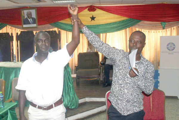 Nana Oduro Numapau (right), the Tema Metropolitan Electoral Officer who supervised the election, declaring Mr Joseph Korto as the Presiding Member-elect for the TMA