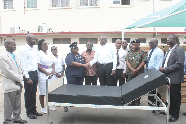 DCOP Dr Mariam Tetteh-Korboe (5th left), the acting Medical Director, Police Hospital, thanking Mr Harry Sitim Aboagye, Executive Chairman, Reha Medical Group, after receiving the beds on behalf of the hospital.  With them are representatives of the hospitals waiting for their turn. INSET: Some of the hospital beds. Picture: BENEDICT OBUOBI