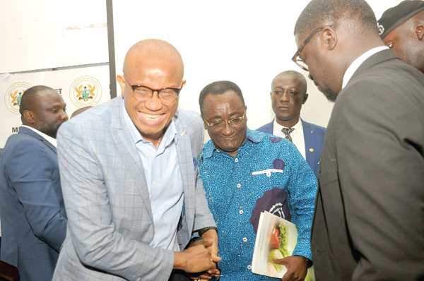 Dr Mustapha Abdul-Hamid, Minister of Information, congratulating Dr Owusu Afryie Akoto, Minister of Food and Agriculture after addressing journalists and other participants at the Ministry’s turn of the Meet-the-Press series. Picture: EBOW HANSON  