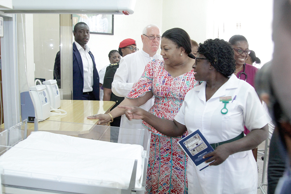 The First Lady, Mrs Rebecca Akufo-Addo (left), inspecting some of the equipment at the newborn care unit after the official opening. 