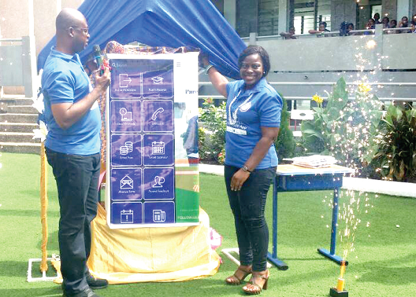 Mr Francis Sawyer (left) and Mrs Emma Dzokoto,  both from the Evangelical Lutheran Church Schools, unveiling the mobile application.