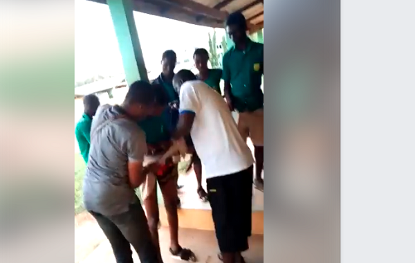 The teachers stripping the victim of his shorts