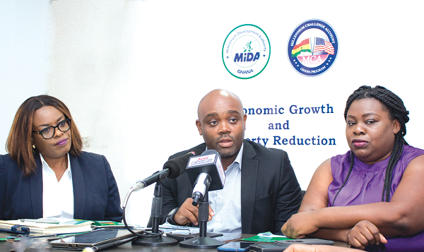 Mr Sylvester Ashong Ayayee (middle) and Ms Pamela Djamson-Tettey (right) explaining what the Energy Efficiency and Demand Side Management project is about