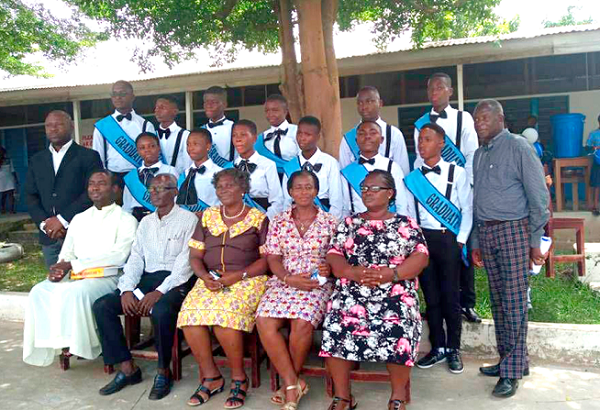 The graduates in a group photograph with the administrators of the school.