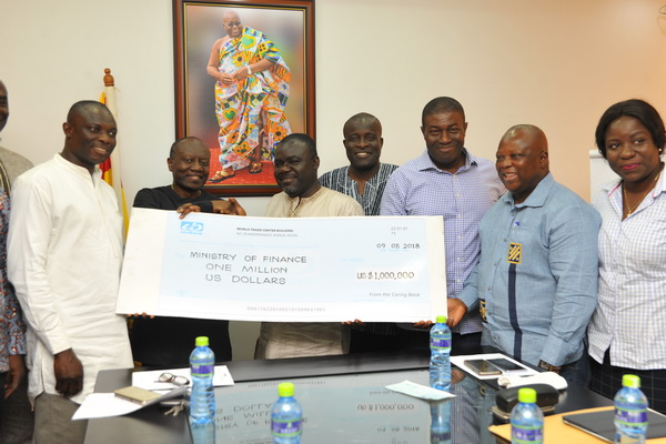 Mr Kwaku Asiamah(3rd-left), Minister of Transport, presenting a dummy cheque for the $1million to Mr Ken Ofori-Atta (2nd left). With them are Mr Kwaku Kwarteng, Deputy Minister of Finance, Mr Samuel Oppong(right), Chairman and Nana Akomea,  (2nd right),Managing Director, respectively of the company.