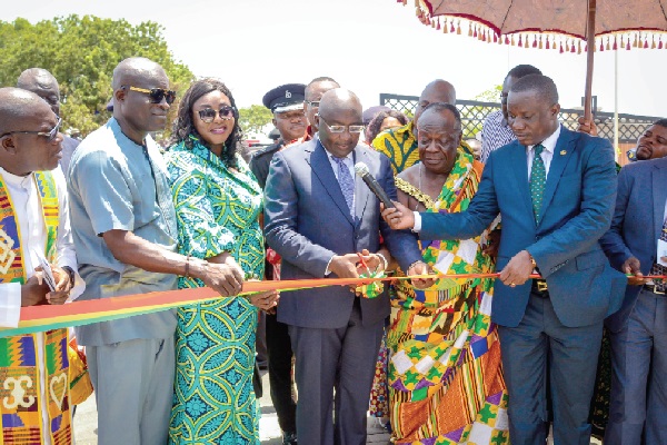 Vice-President Bawumia (with scissors) being assisted by Nii Adjei Krakue (2nd right), Tema Mantse, to cut the tape  to inaugurate the Phase II of the Security Services Housing Scheme at the Eastern Naval Command, in Tema New Town.