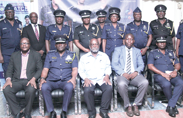 Mr David Asante-Apeatu (seated, 2nd left ), Prof. Kwame Karikari (3rd left), Board Chairman, GCGL,  and some officials of the police after the launch