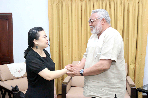 Former President Rawlings in a handshake  with Madam Sun Baohong, the outgoing Chinese Ambassador to Ghana