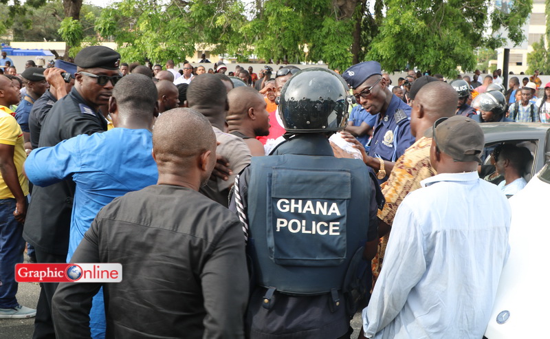 Police and supporters of the National Democratic Congress face off following the arrest of Koku Anyidoho