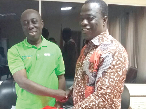 Mr Yaw Ofori Debrah (left), the President of GFD, presenting the draft document to Mr Ignatius Baffour Awuah, the Minister of Employment and Labour Relations