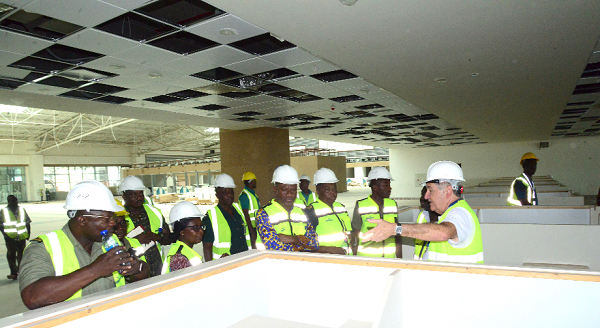 Mr Kwame Asuah Takyi (3rd right) and his entourage being briefed by Mr Fernando Prieto (right) at the immigration work stations