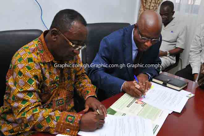 Dr Afriyie Osei Akoto(left), signing the memorandum of understanding with Mr Kouame Miezan at the Ministers office in Accra