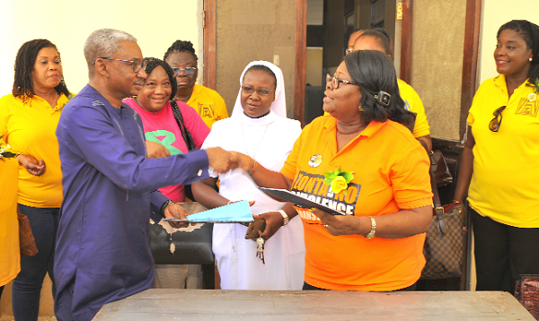 Dr Ali Samba, the Head of the Gynaecology and Obstetrics Department, exchanging documents  with Mrs Margaret Martin-Daniels, the President of ZONTA International Accra II,  after signing an MoU   to support the Chinaard Ward of the Gynaecology and Obstetrics Department of the Korle Bu Teaching Hospital for the next 10 years. 
