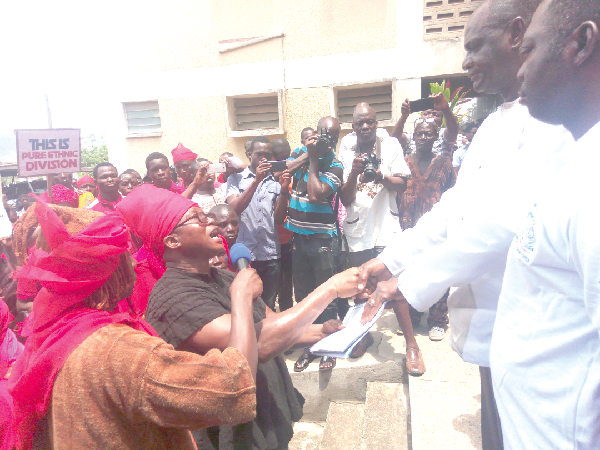 Mr Simon Kofi Ohene (left) presenting the petition to Mr Felix Chaaha