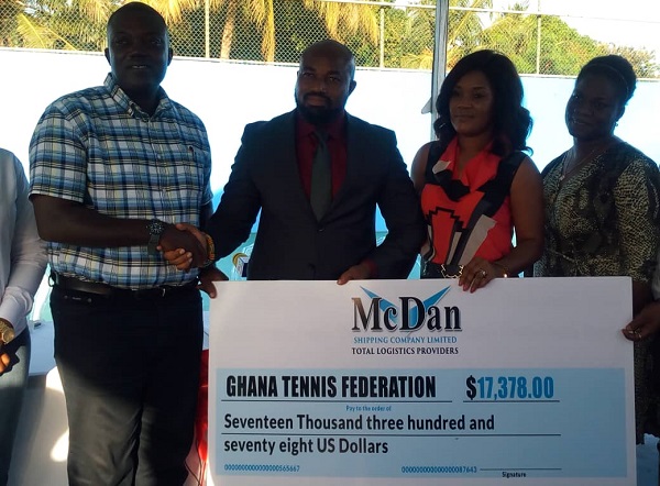 Mr Daniel McKorley presenting the dummy cheque to GTF President Isaac Aboagye Duah (far left)