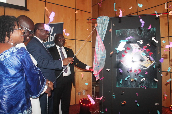 Dr Mahamudu Bawumia (4th left)  unveiling a plaque to launch the Mobile Money Interoperability. Assisting him are Dr Ernest Addison (3rd left),  Mr Ken Ashigbey (2nd left), and  Mrs Elly Ohene Adu (left), Board Member of GhIPSS