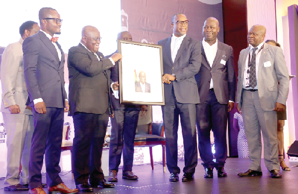Mr Edward Effah (3rd right), Executive Chairman, Stanbic Bank, presenting an award to President Akufo-Addo for his contribution to the country as the Chief CEO at the 3rd CEOs Summit in Accra. Picture: SAMUEL TEI ADANO