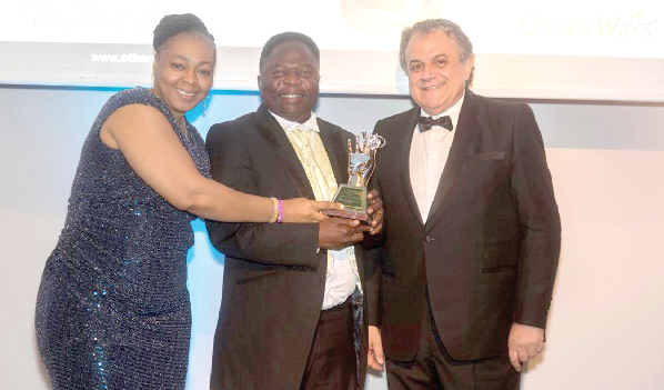 The CEO of Medi Moses Prostate Centre, Dr Moses Dogbatsey (middle), and his wife, Mrs Juliana Dogbatsey, receiving the award from the CEO and President of Otherways Management Association and Consulting, Mr Charbel S. Tabet.