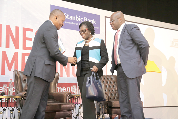 Mr Vish Ashiagbor (left), Senior Partner, PwC shaking hands with Ms Elsie Addo Awadzi (middle), Second Deputy Governor, Bank of Ghana and Mr Kwamina Asomaning, Director, Corporate and Investment Banking, Stanbic Bank after the meeting.