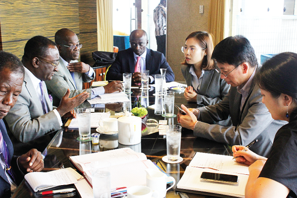 Dr Akoto (left) explaining a point to Mr Xi-An (2nd right) and Ghana’s Ambassador to China, Mr Boateng (middle). With them are some members of the delegation.
