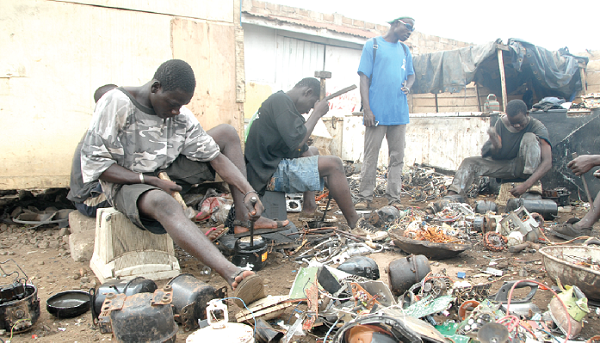 Young people busily extracting materials from scrap