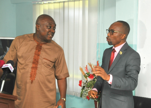 Mr Kwabena Ofosu -Appiah (right), the President of the Ghana Institute of Freight Forwarders (GIFF), interacting with Mr Carlos Ahenkorah, a Deputy Minister of Trade and Industry,  after the news  conference in Accra
