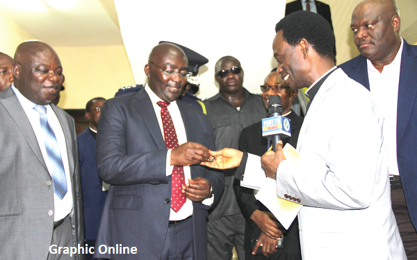 Apostle Prof. Opoku Onyinah (2nd right) handing over the keys to the new police station to Vice President Dr Mahamudu Bawumia (2nd left), during the ceremony. Looking on are Mr Thomas Yaw Adjei-Baffoe (left), Deputy Central Regional Minister, and Mr Henry Quartey (right), a Deputy Minister of the Interior. Picture: EDNA ADU-SERWAA