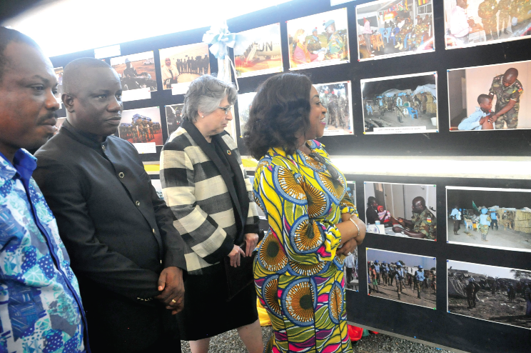 Ms Shirley Ayorkor Botchwey (right), Mr Dominic Nitiwul (left), Minister of Defence, and Ms Christine Evans-Klock looking at photographs on Ghana’s peacekeeping operations which were mounted as part of the ceremony. Pictures: EBOW HANSON