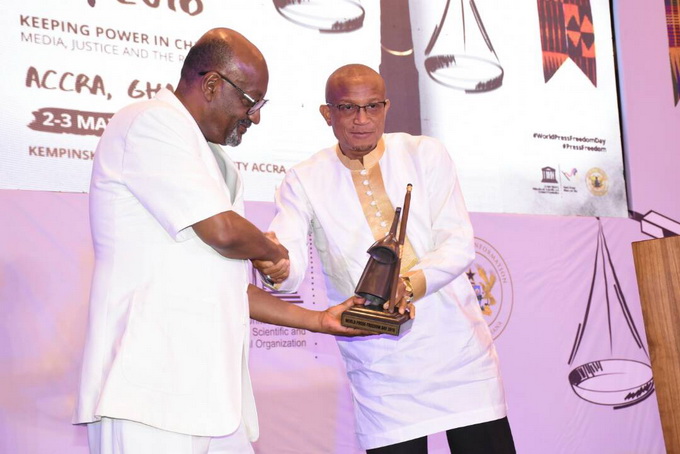 Dr Mustapha Abdul-Hamid, the Minister of Information, handing over a ‘gong-gong’ to Mr Getachew Engida, the Deputy Director-General of UNESCO, to symbolise the official closure of the World Press Freedom Day held in Accra