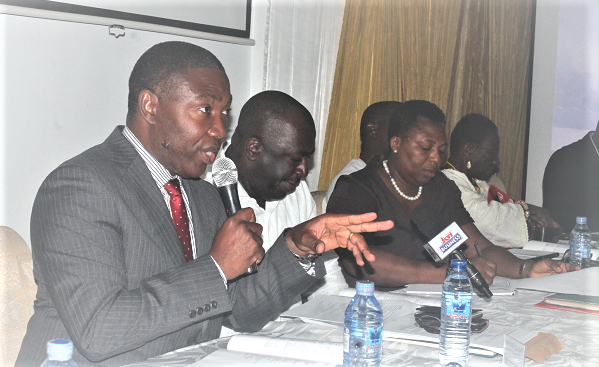Mr David Klutse (left), Managing Director of Intravenous Infusions Plc, speaking at the annual general meeting. Also in the photograph are Mr Leon Appenteng (2nd left), Board Member and Mrs Felicia Kpegah (3rd left), Head of Secretarial Services, Dehands Services Limited. Picture: Maxwell Ocloo