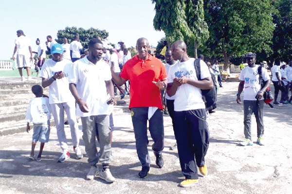 Herbert Mensah (middle) explaining a point to some of the participants in the walk