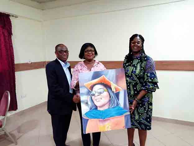 The Acting President of AUCC, Dr. Christopher Akwaa-Mensah (Left) presenting a giant portrait to Dr. Koryoe Anim-Wright. Looking on is Prof. Margaret Crabbe, Dean of the Sam E. Jonah School of Business