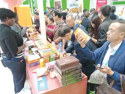 Chinese visitors to the Ghana Country Stand examining some items on display