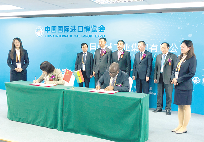 Mr Emmanuel Opoku (right) and Mrs Yang Jing signing the agreement