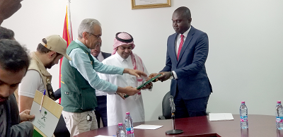  Mr Charles Owiredu (right) recieving documents containing the medical items from Mr Almajed (middle). With them are some offocials from the Saudi Embassy