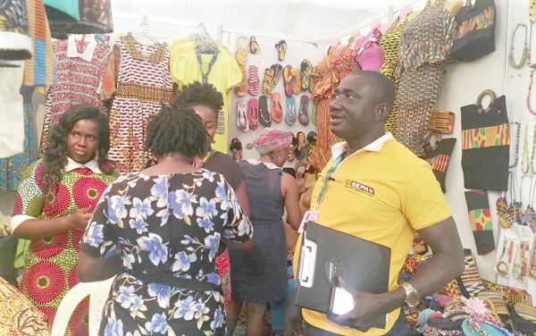 Mr Maxwell Osei-kusi interacting with a Ghanaian  exhibitor.