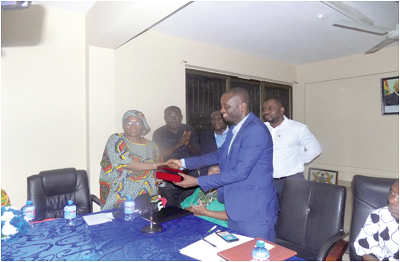 Madam Barbara Roberts Mason and the MCE, Mr Isaac Kwadjo Buabeng, exchanging documents after signing the MoU