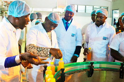  Mr Kwakye Darfour (second left) affixing  a tax stamp on a product at the Fedex Enterprise. With him are Mr Collins Asare (extreme left), Mr Gadzanku (extreme right) and Mr Samuel Nuertey Ayertey (second right)