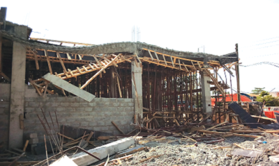 A tractor clearing the debris of the collapsed building at the Dzowulu Primary School