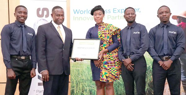 Mr Joe Mensah (2nd left) presenting a certificate to Ms Caroline Pomeyie and the Profish Team