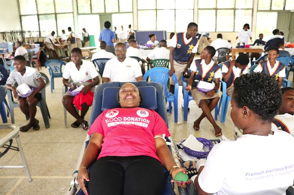  A member of the Power Queens Club donating blood, while the students await their turn 