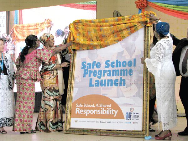  Mrs Samira Bawumia (left), and Mrs Cynthia Mamle Morrison (right), being assisted by Ms Joyce Rhodaline Addo (2nd left), Headmistress of Achimota School to unveil  a poster at the ceremony.  Picture: ESTHER ADJEI